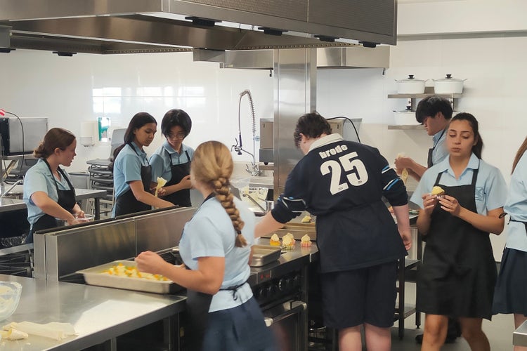 A group of students working in the commercial kitchen