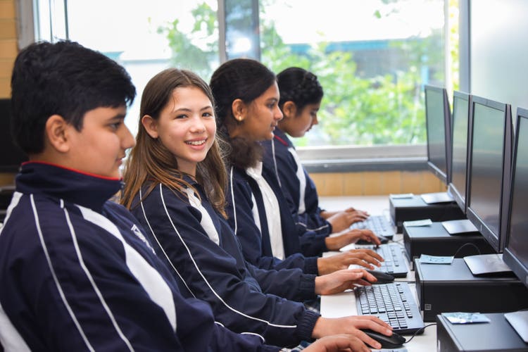 Four students using computers in a computer space